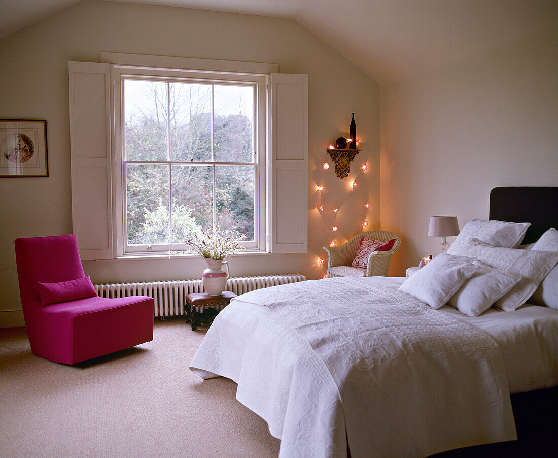 Double bed in bedroom decorated with fairy lights