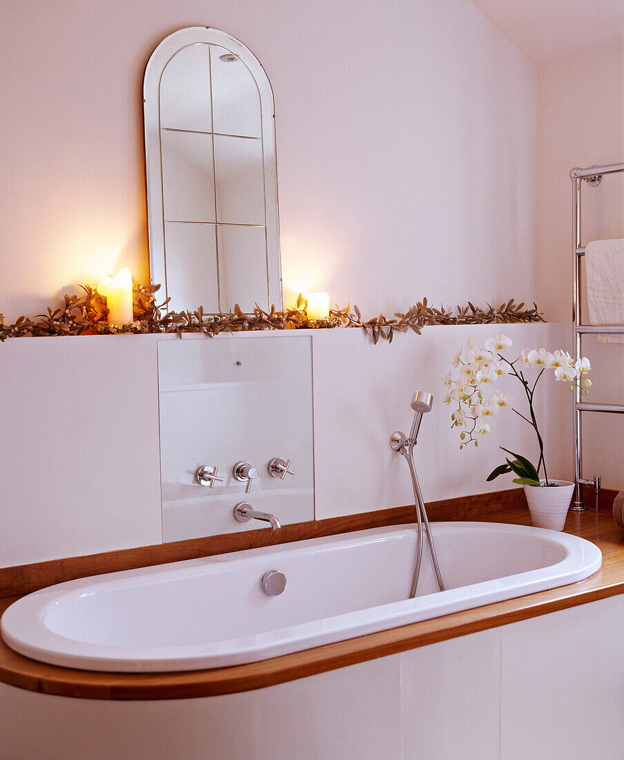 Bathtub set in surround with lit candles