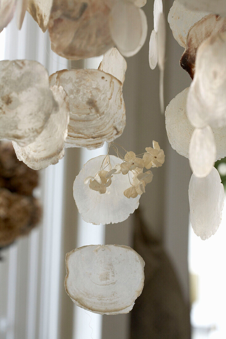 Close up of shell like discs hanging from chandelier