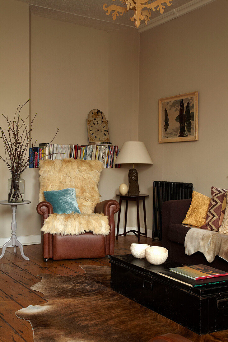 Fur throw on corner chair in living room of Brighton home, East Sussex, England, UK