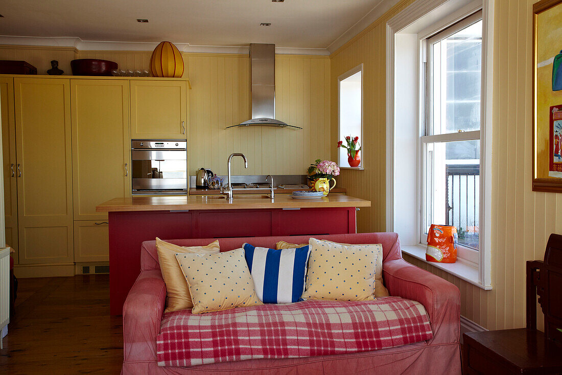 Spotted cushions on sofa in open plan kitchen living room of Cromer beach house, Norfolk, England, UK