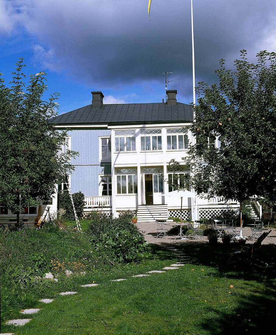 Exterior of blue painted timber house with veranda