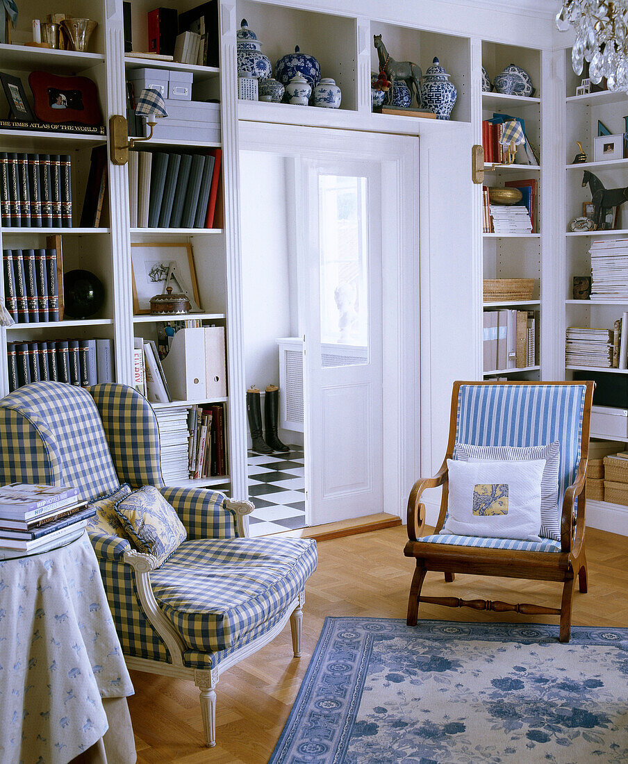 Upholstered armchair in check fabric in front of book shelves