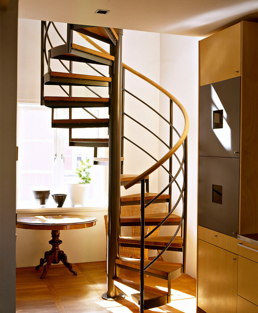 Modern spiral staircase with wooden steps