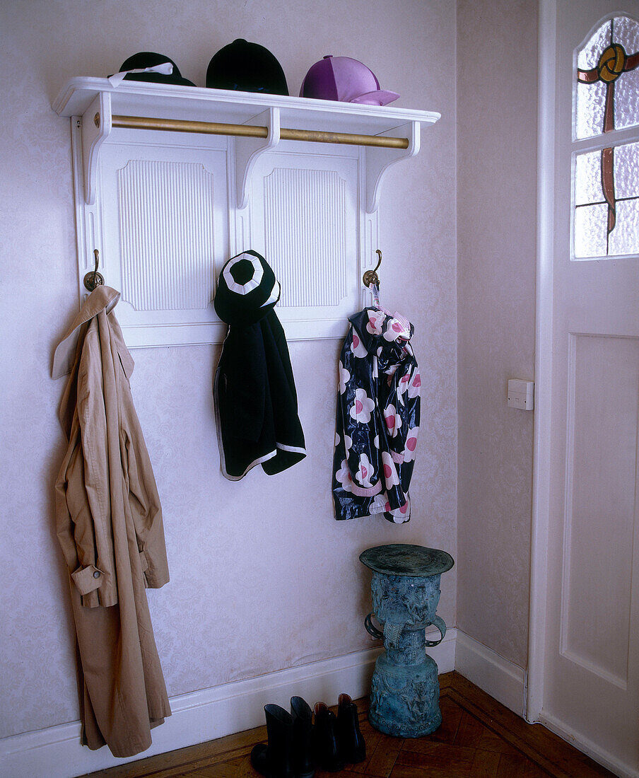 Traditional hallway detail with coat rack and shelf
