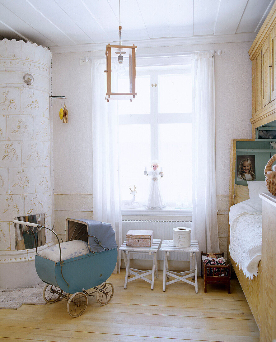 Traditionally Scandinavian tiled stove in child's bedroom