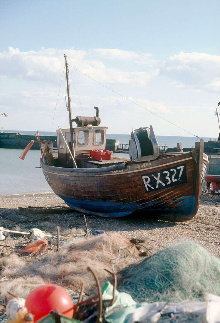 A wooden fishing boat on a beach