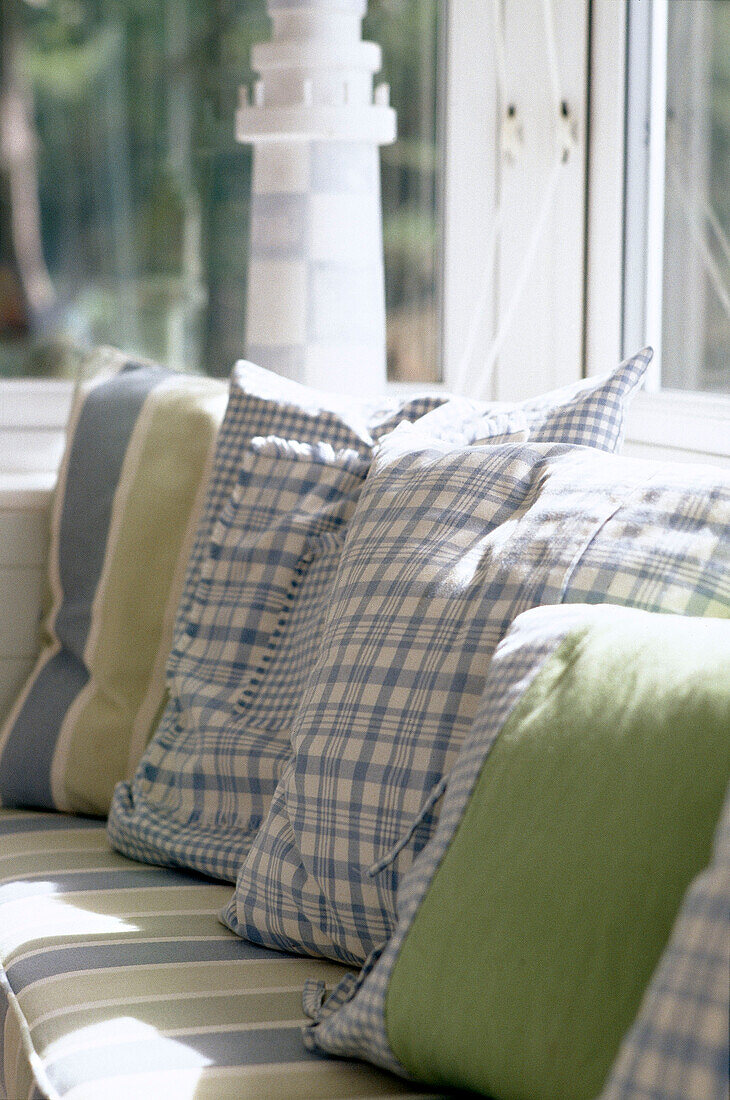 Blue and green pattern cushions on sofa