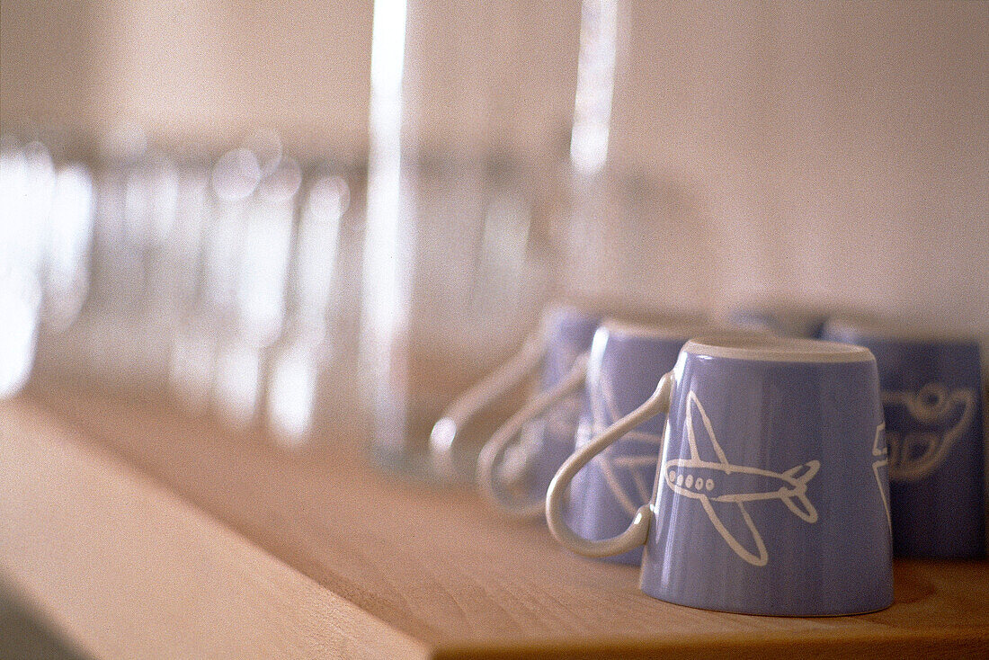 Blue pottery cups upside down on shelf