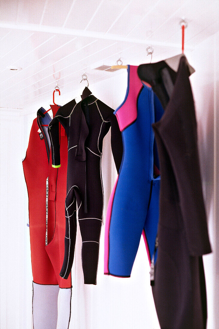 Wet suits hanging up