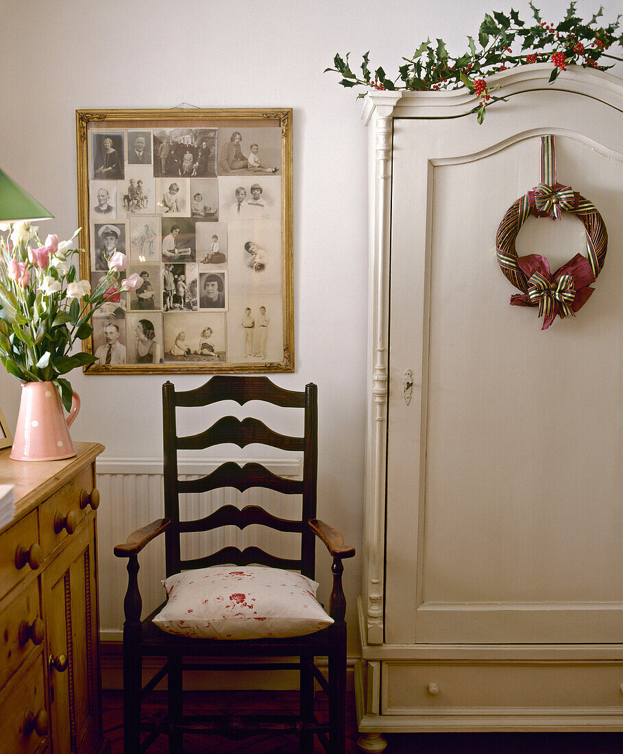 Ladderback wood armchair next to wardrobe decorated for Christmas