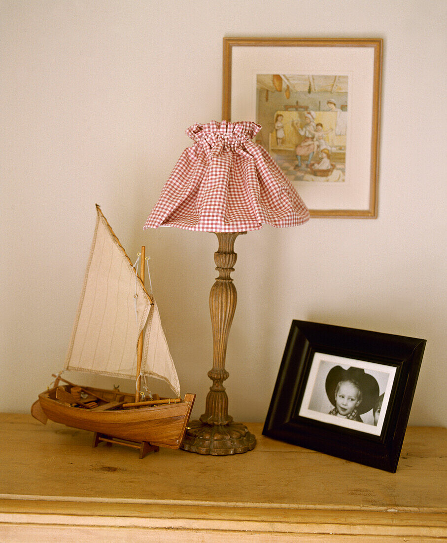 Model boat and wood lamp on shelf