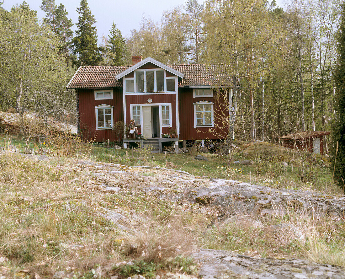 Exterior of a traditional wooden house on a wooded hillside