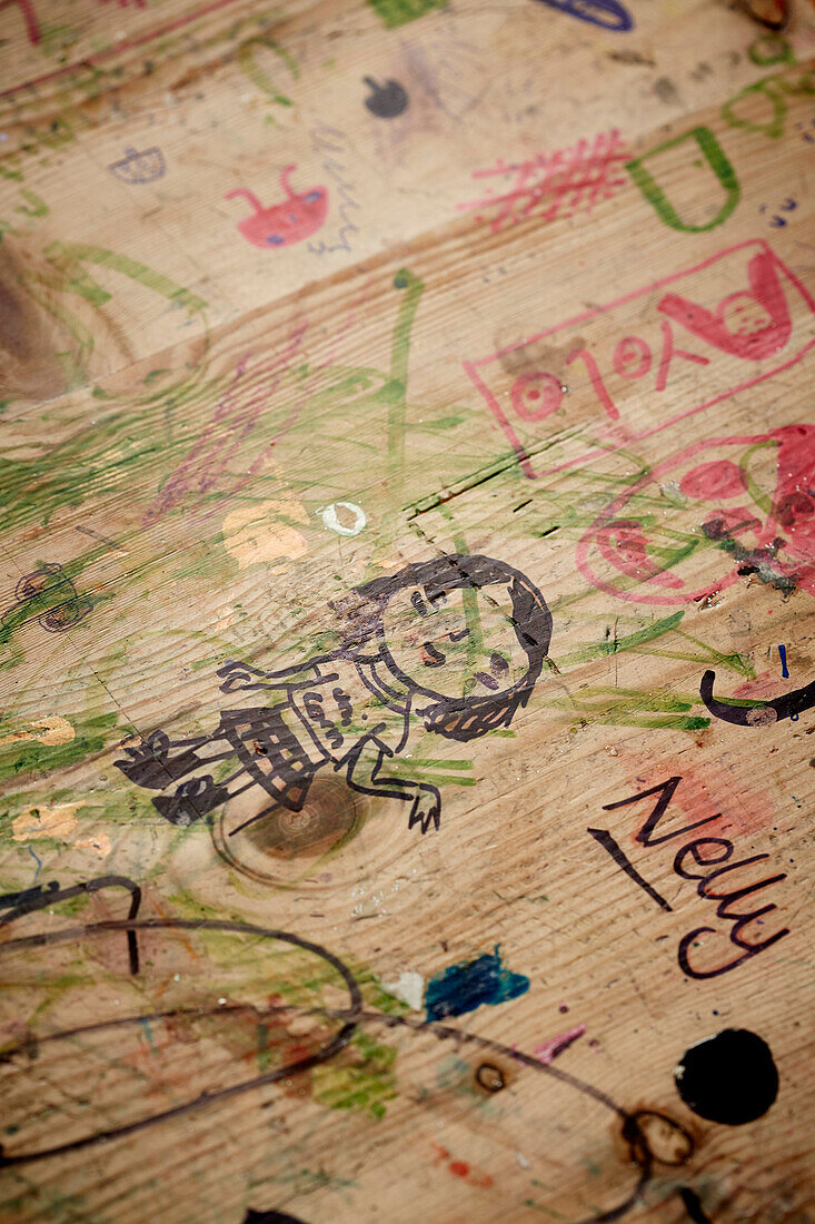 Scribbles and sketches on wooden surface in Bridport home, Dorset, UK