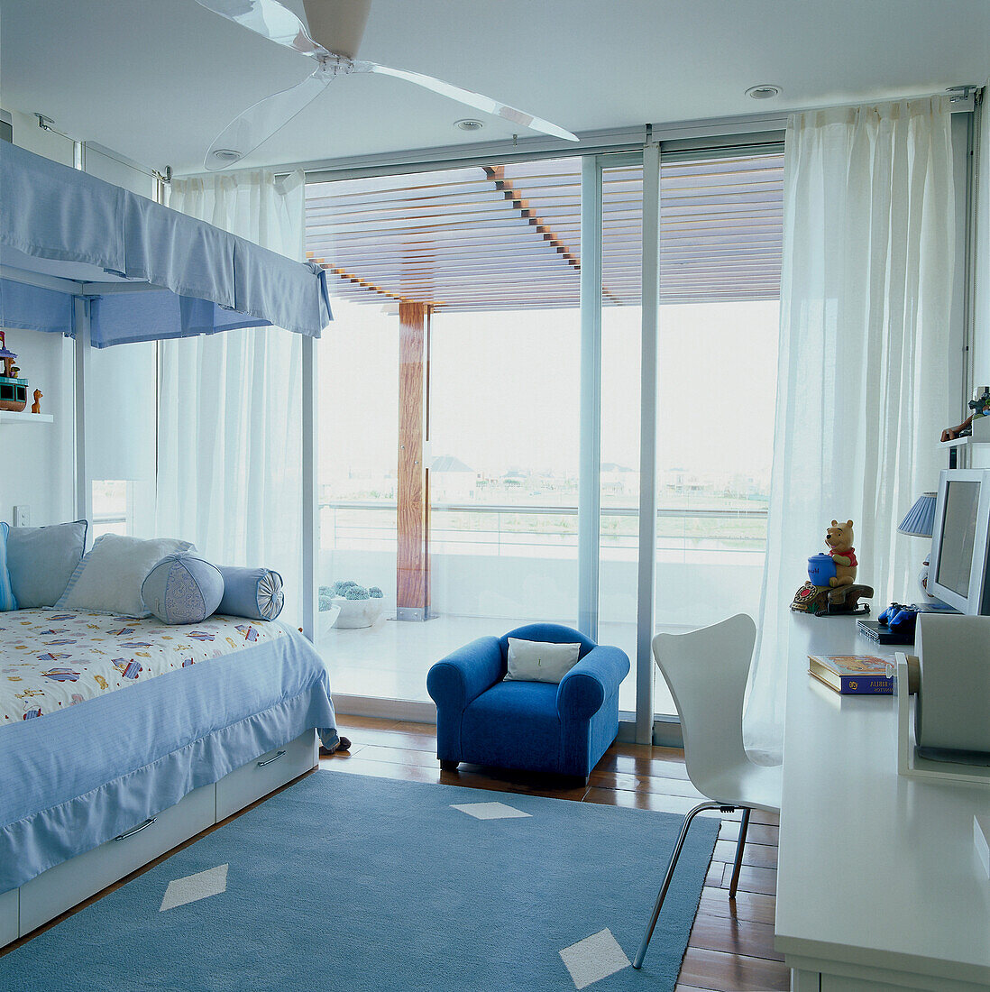 Blue child's bedroom with view to balcony