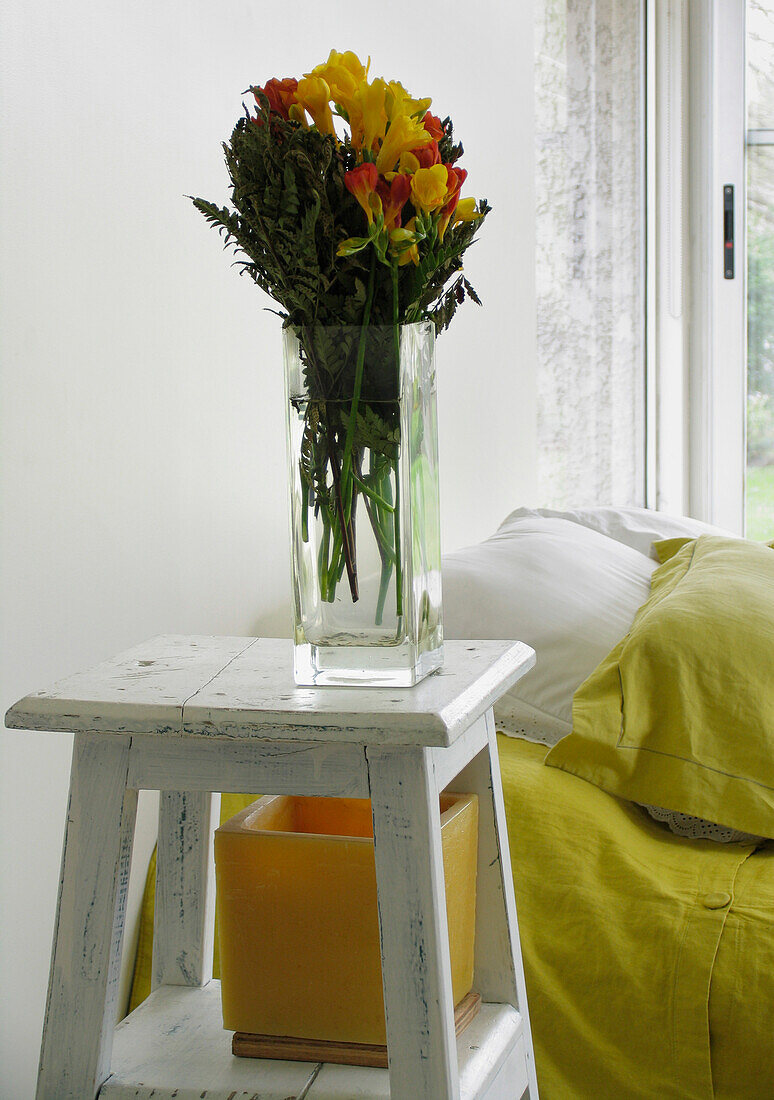 Flower arrangement on a bedside stool
