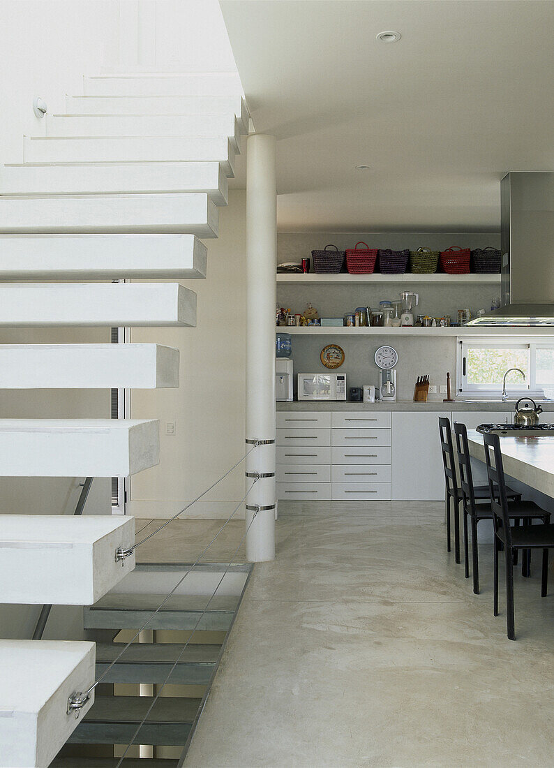 Kitchen with dining room concrete flooring and floating staircase
