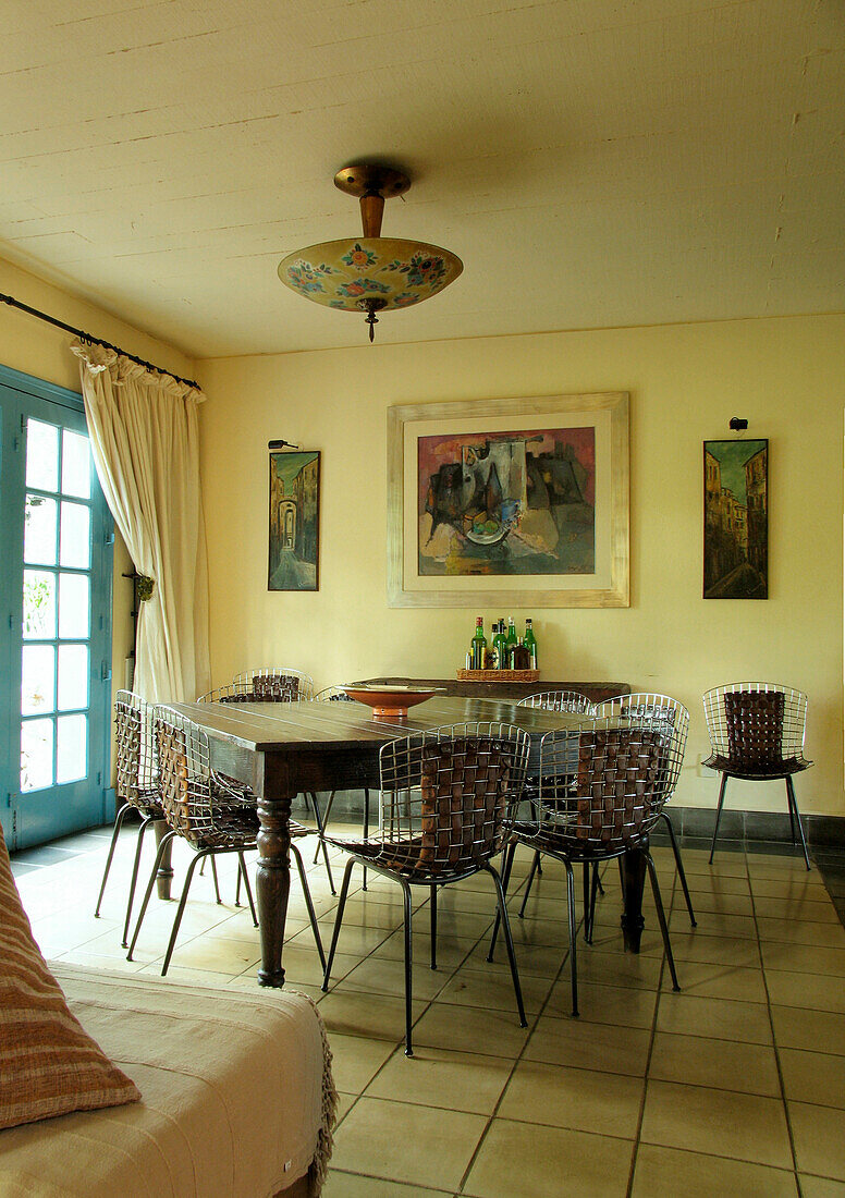 Dining room with leather and metal woven chairs