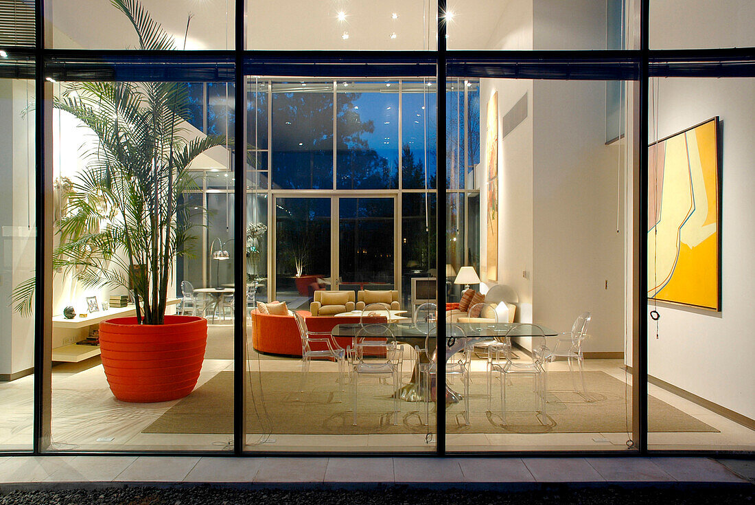 View to interior through glass cube facade in minimalist style