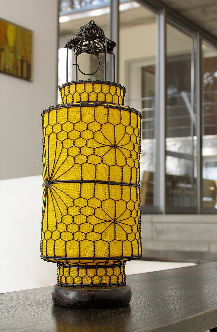 Close up of colourful Chinese style yellow cloth and wirework lantern in modern living room