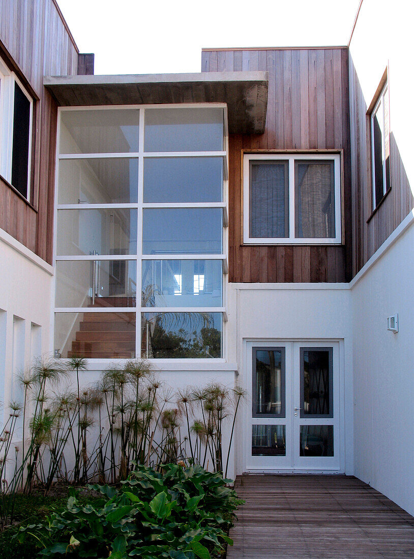 Double height windows on decked building exterior and porchway