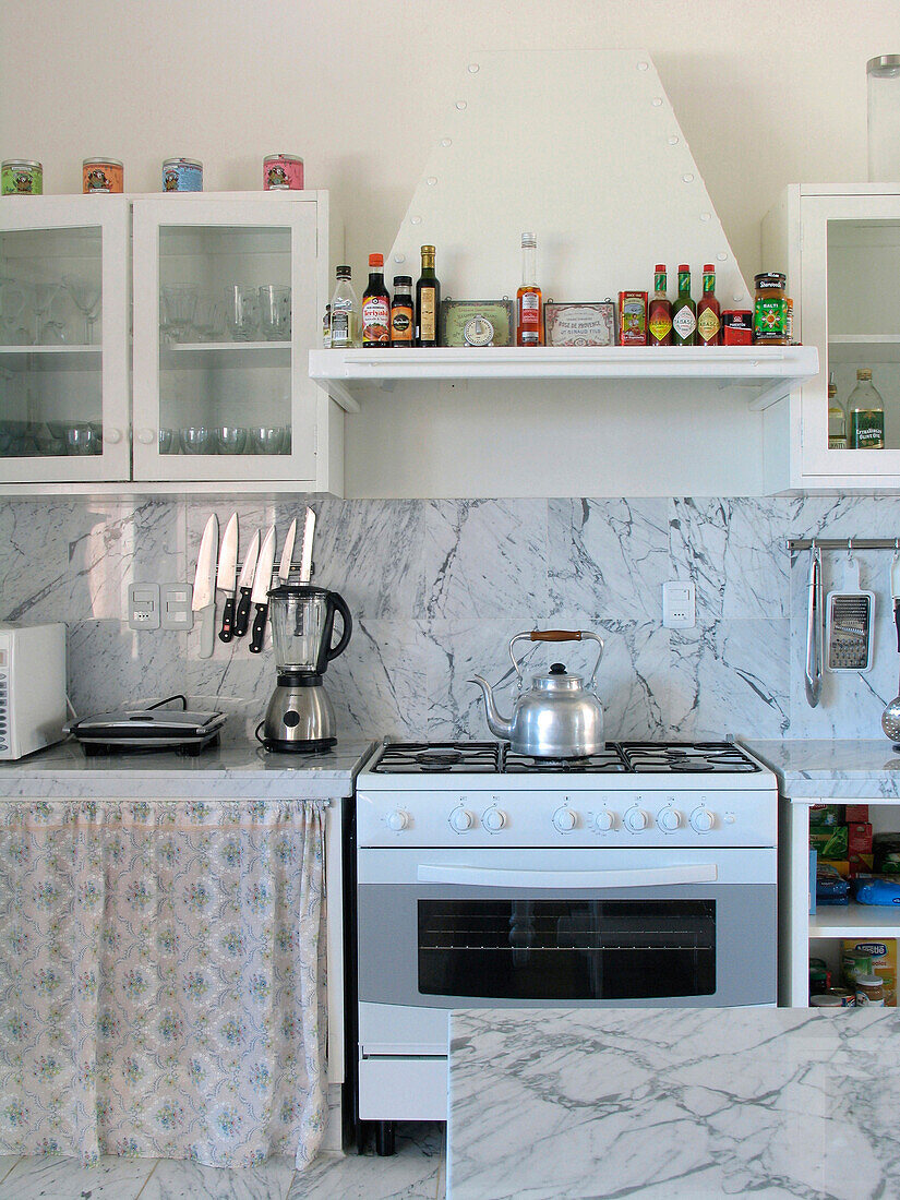 Vintage kitchen with fabric covered unit and kettle on hob