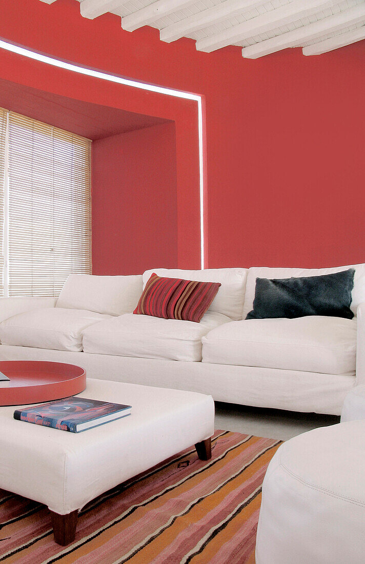 Red living room with white upholstered furniture