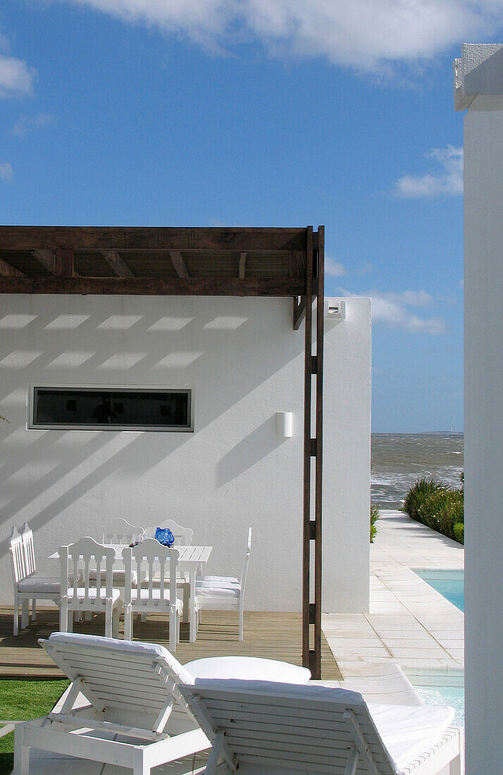 Swimming-pool with a direct view of the sea and a tiled path leading to the beach