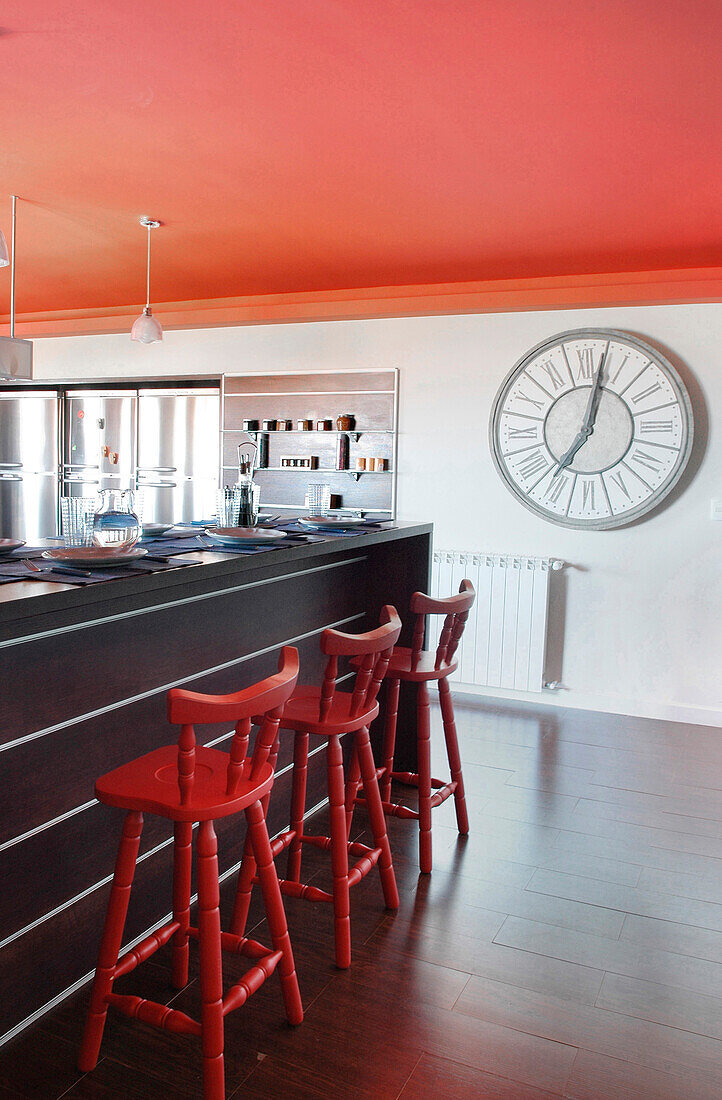 Kitchen with red ceiling and oversized clock