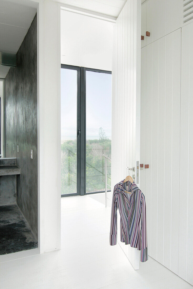 Blick durch eine übergroße Tür vom Schlafzimmer mit eigenem Bad und Glasschiebetür