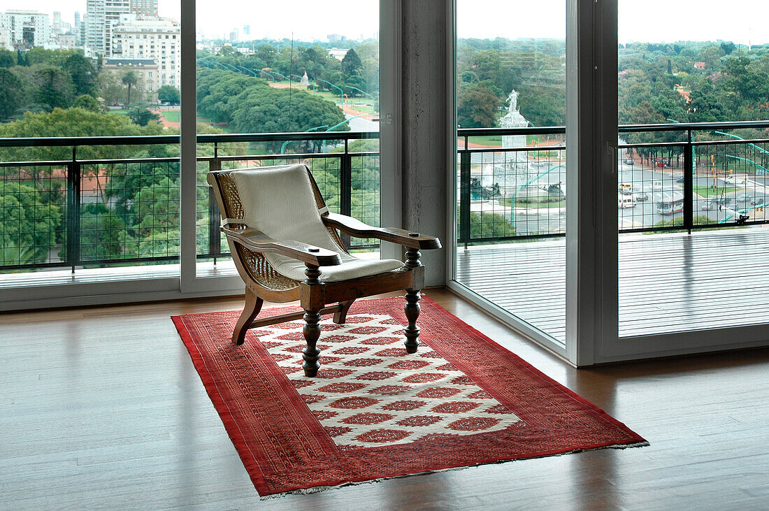 Antique chair on patterned rug in city apartment