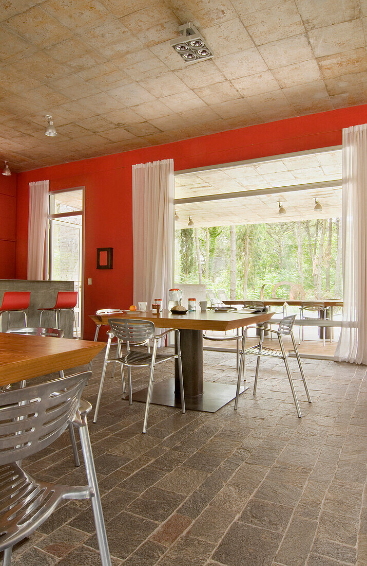 Red kitchen with metal framed chairs at table