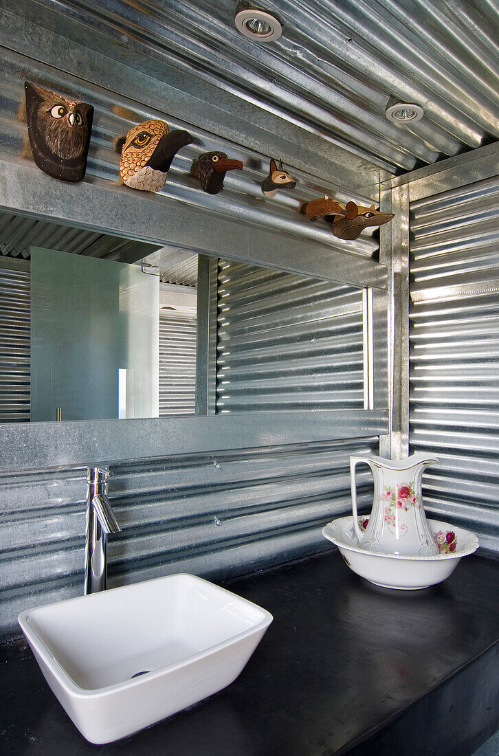 Badezimmer mit verzinkten Blechen, rechteckigem Spiegel und Duschabtrennung