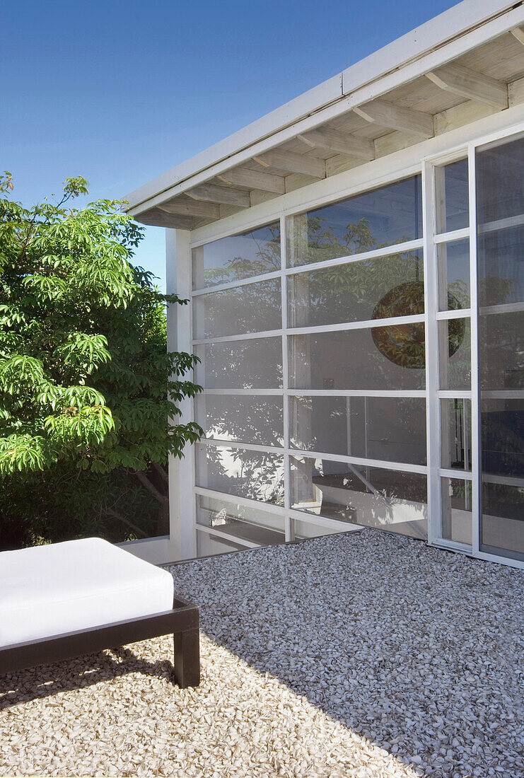 Gravel terrace of glass walled building exterior