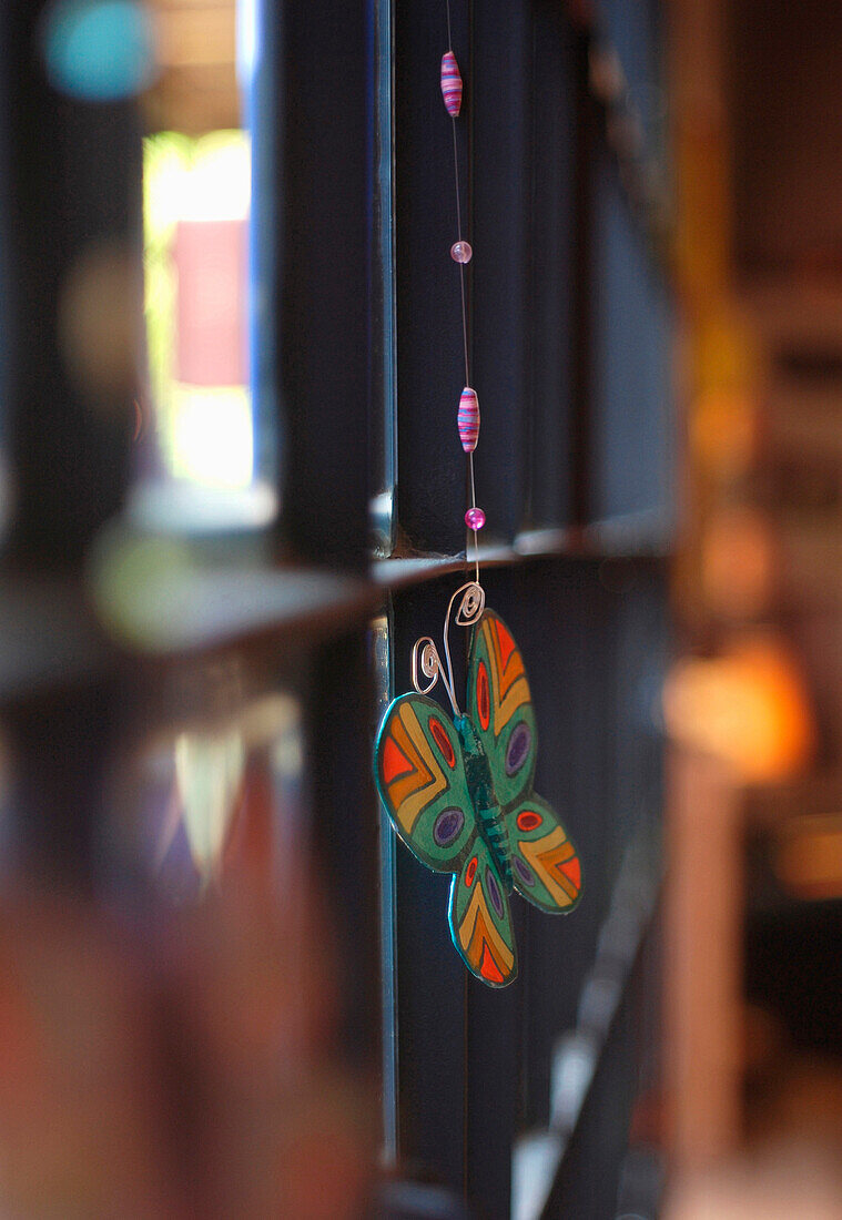 Butterfly ornament hanging from large glass window