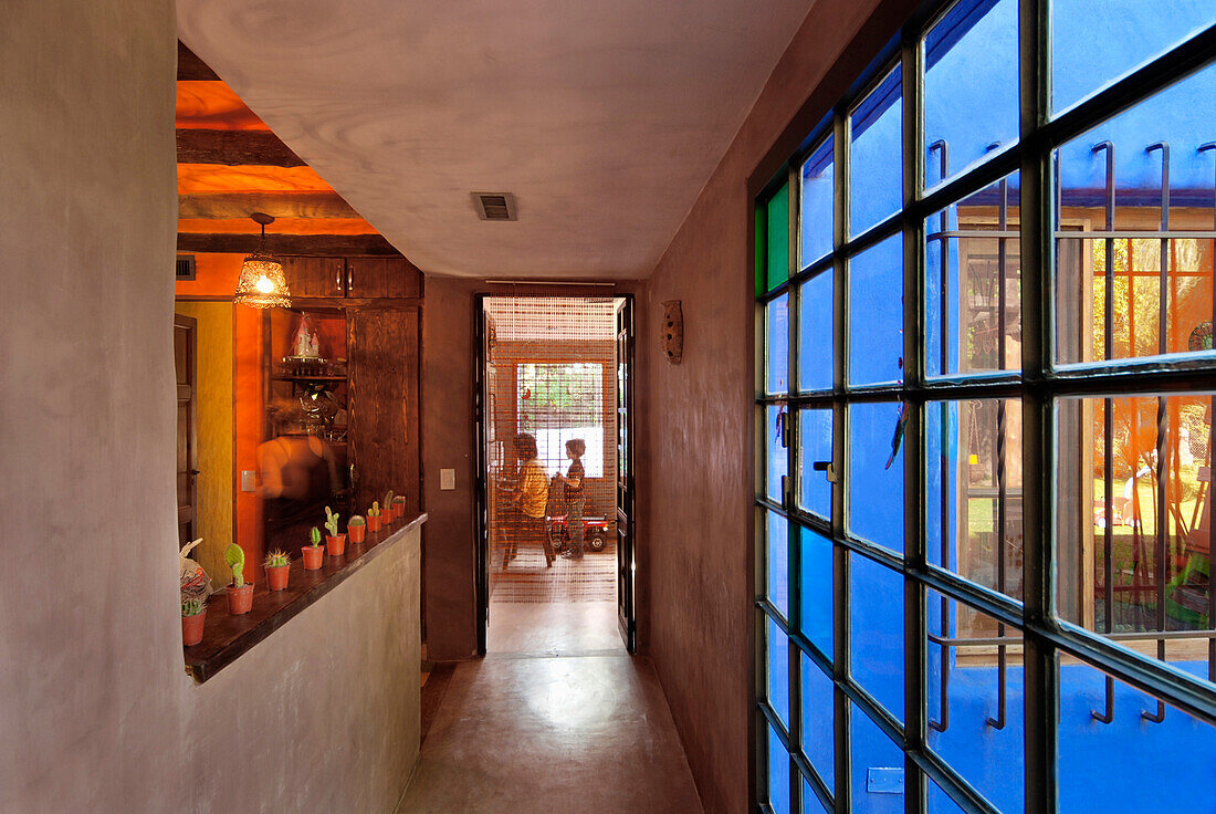 Kitchen corridor with a beautiful large window combining transparent glass and colour panes
