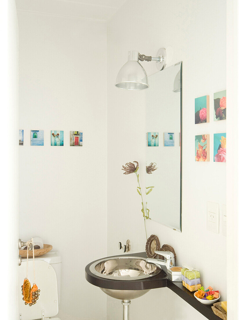 Metal lamp over mirror with stainless steel wash basin