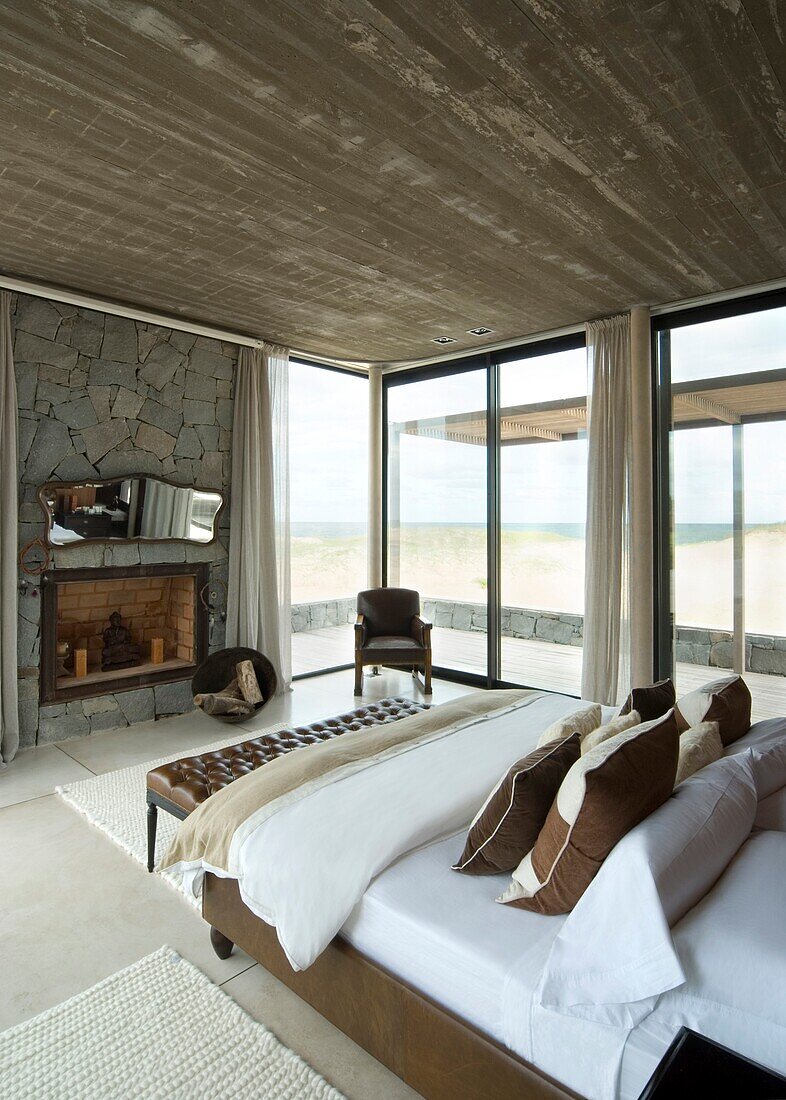 Uruguay, modern bedroom with fireplace