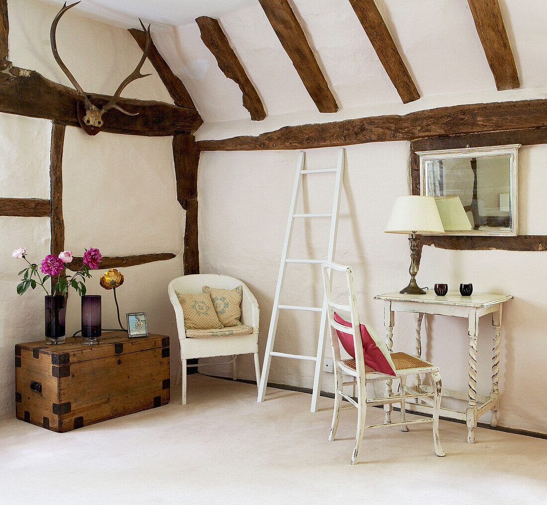 Salvaged furniture and painted ladder in corner of room in 17th Century Oxfordshire home