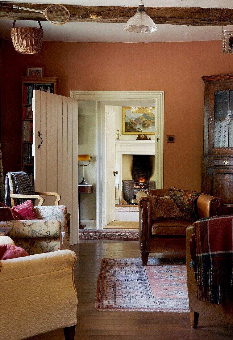 Seating area of country house with view through low doorway