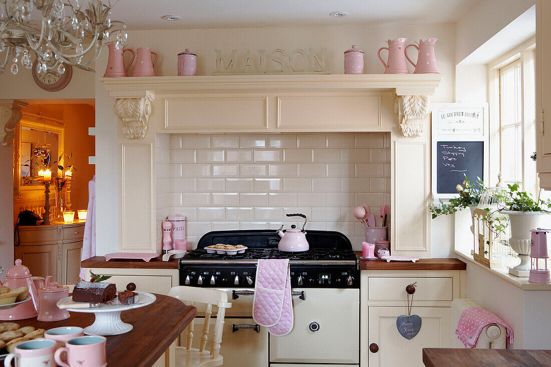 Sunlit cream kitchen with pink accessories