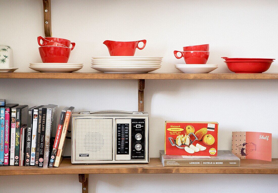 1050s crockery DVDs and a retro radio on wooden wall shelving