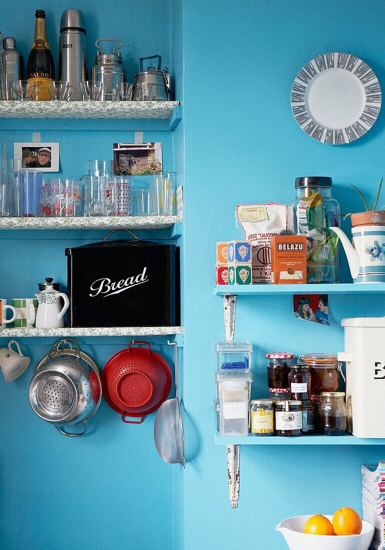 Kitchenware on open shelving of 1950s style kitchen
