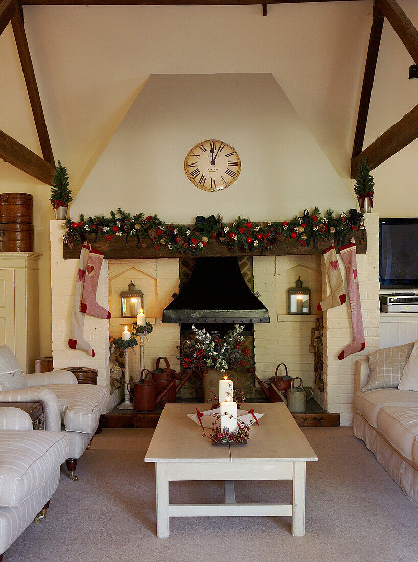 Christmas stockings hang on fireplace in barn conversion