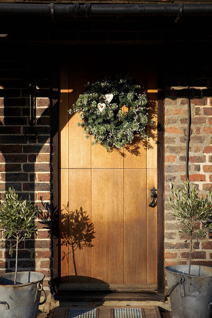 Christmas wreath on wooden front door 