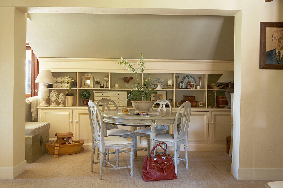 Circular table and chairs with under eaves storage in farmhouse conversion