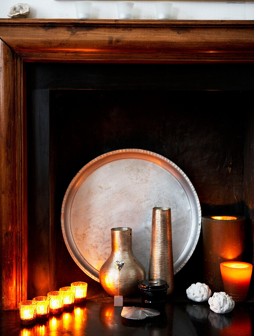 Lit candles and silverware in fireplace of Grade II listed Georgian townhouse in London