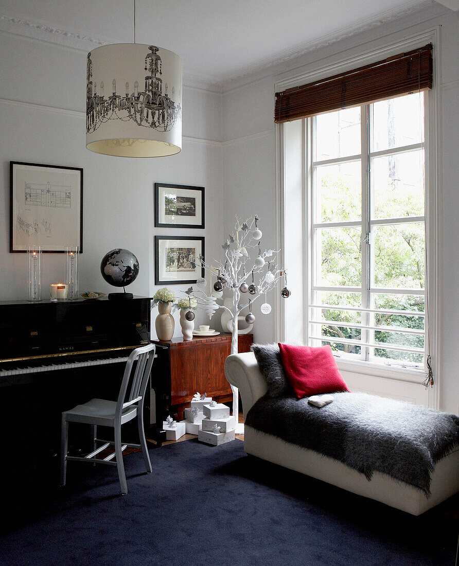 Grey blanket on daybed in window of piano room in Grade II listed Georgian townhouse in London