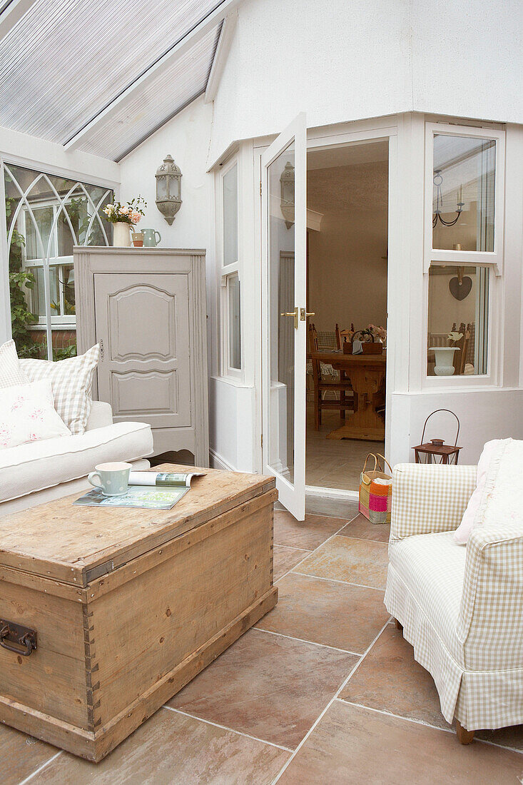 Wooden travelling chest in conservatory extension 