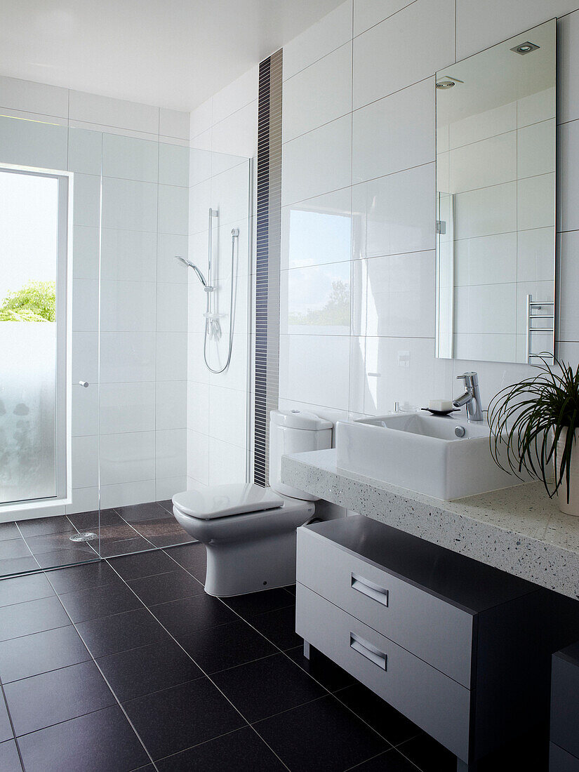 White tiled bathroom with glass shower screen